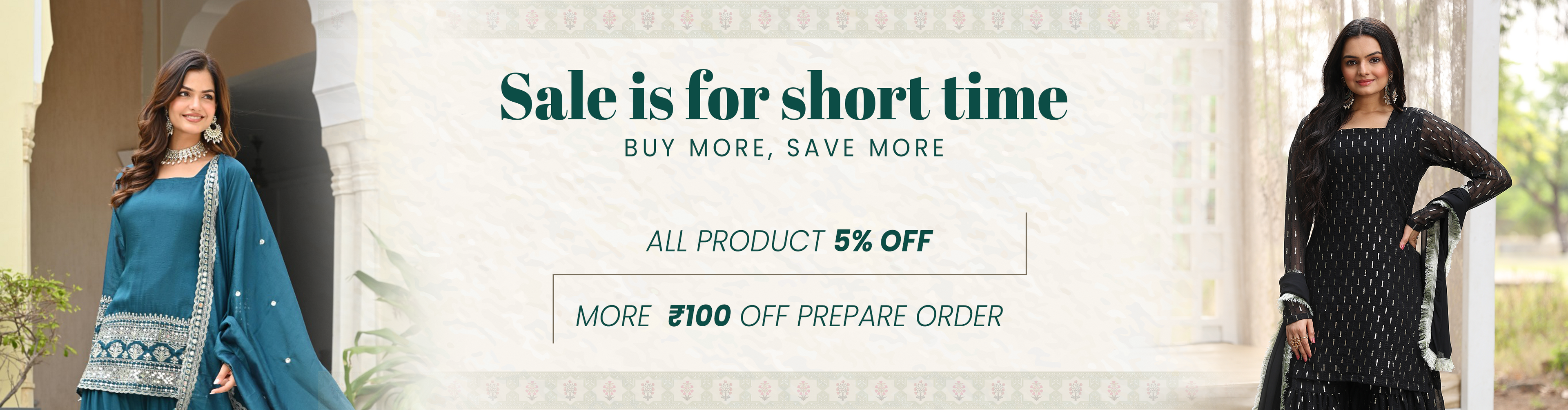 Two women in traditional attire with a promotional banner for a sale event.