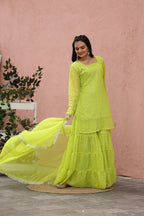 Woman wearing a bright yellow sharara with a pink background