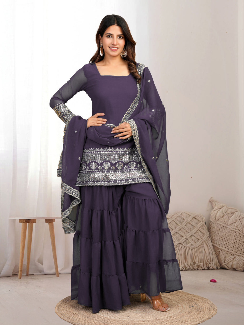 Woman wearing a onion outfit traditional outfit with silver embroidery on a white background