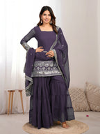 Woman wearing a onion outfit traditional outfit with silver embroidery on a white background