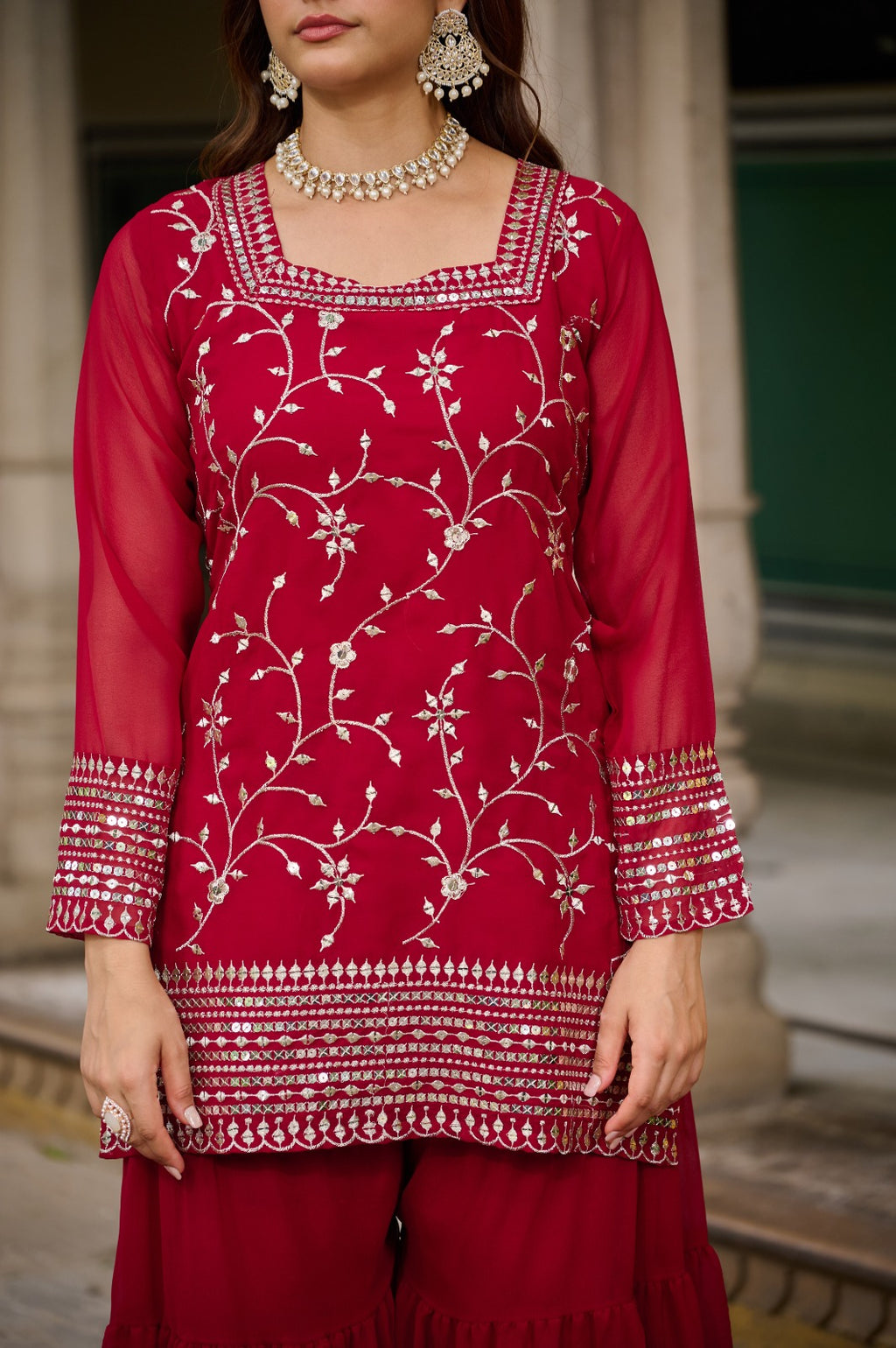 Woman wearing maroon embroidered kurta sharara set