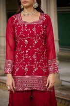 Woman wearing maroon embroidered kurta sharara set