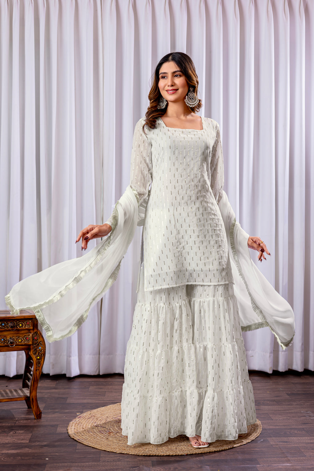 Woman wearing a white traditional outfit with a plain background