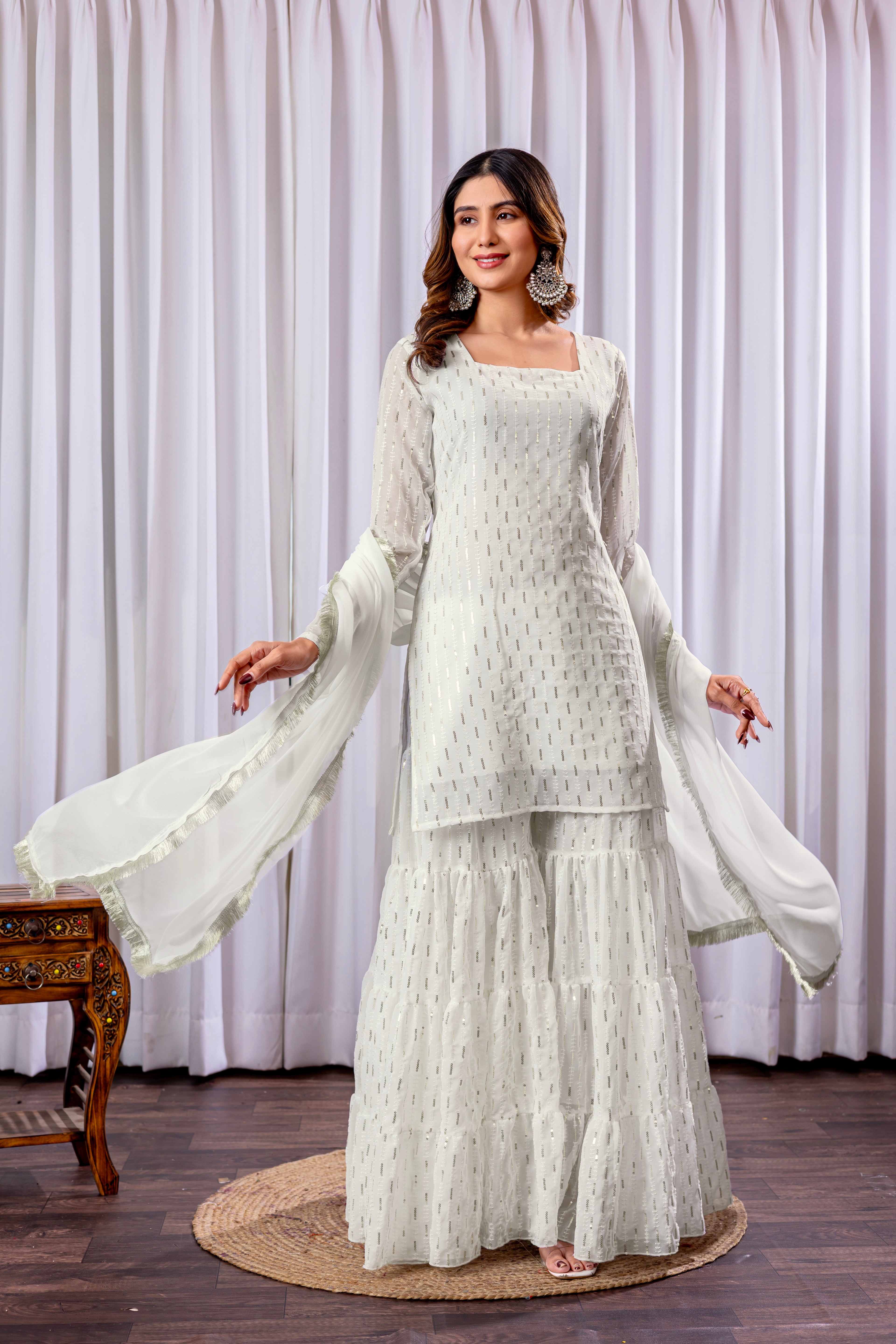 Woman wearing a white traditional outfit with a plain background
